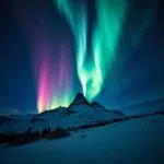 Aurora Borealis Over Snowy Peaks