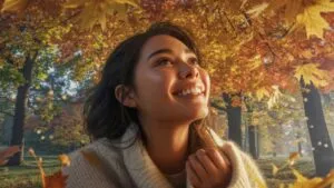 Girl Smiling Under Golden Autumn Leaves