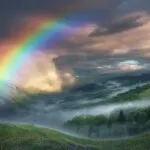 Rainbow Arching Over Valley After Rain Stormy Sky