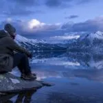 Traveler Resting Beside a Mountain Lake