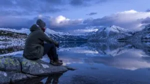 Traveler Resting Beside a Mountain Lake
