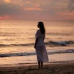 Woman Gazing at the Horizon by the Beach