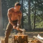 Attractive Man Chopping Firewood Outdoors