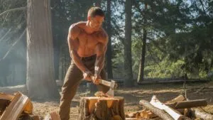 Attractive Man Chopping Firewood Outdoors