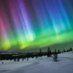 Aurora Lights Above Snowy Landscape