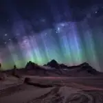 Blue Aurora Above Dark Mountain Peaks