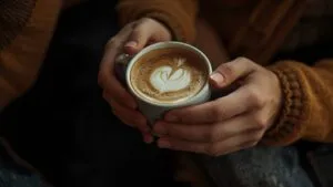 Close-Up of Hands Holding a Coffee Cup Together