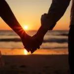 Couple Holding Hands at Sunset Beach