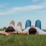 Couple Lying on Grass Watching the Sky