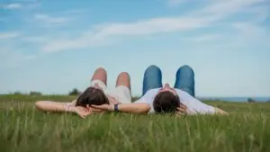 Couple Lying on Grass Watching the Sky