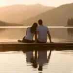 Couple Sitting by Lake with Reflections