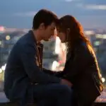 Couple Sitting on Rooftop Watching the City