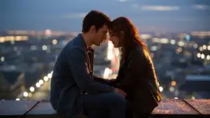 Couple Sitting on Rooftop Watching the City