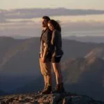 Couple Standing on Mountain Ridge