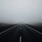 Empty Road Through the Fog