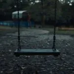Empty Swing Slowly Moving in Wind