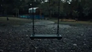 Empty Swing Slowly Moving in Wind