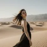 Girl Standing on Desert Dunes