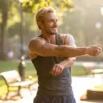 Guy Stretching Before a Workout in the Park