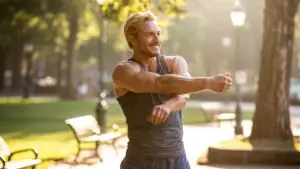 Guy Stretching Before a Workout in the Park