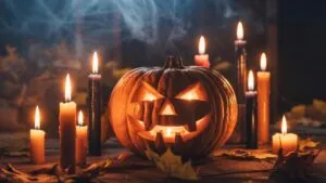 Halloween Candles Beside Carved Pumpkin