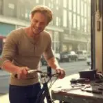 Man Fixing His Bike in a Street Garage