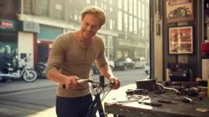 Man Fixing His Bike in a Street Garage