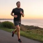Man Jogging on Coastal Path During Sunrise