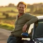 Man Leaning Against His Car on a Country Road
