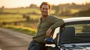 Man Leaning Against His Car on a Country Road