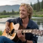Man Playing Guitar by the River