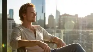 Man Sitting on Balcony Overlooking the City Morning