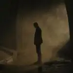 Man Standing in Dim Tunnel