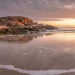 Rocky Beach With Soft Waves at Sunrise