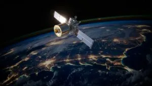 Satellite Orbiting Earth With City Lights Visible