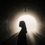 Silhouette in Dim Tunnel