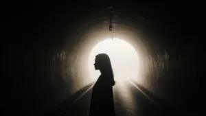 Silhouette in Dim Tunnel