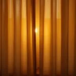 Soft Glow Behind Closed Curtains