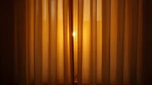 Soft Glow Behind Closed Curtains