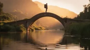 Traveler Standing on Bridge Over River