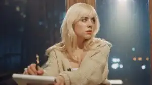 Billie Eilish Writing Lyrics Beside a Window