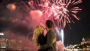Couple Hugging Under Fireworks