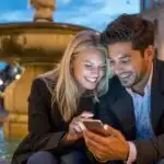 Couple Sitting by Fountain in Evening