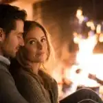 Couple Sitting Close by a Warm Fireplace