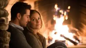 Couple Sitting Close by a Warm Fireplace