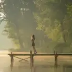 Girl Standing by Lake in Morning Fog