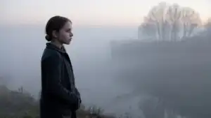 Girl Standing in Cold Foggy Morning