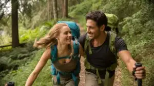 Happy Hiking Couple Walking Through the Forest