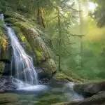 Majestic Cascade Plunging Into Foggy Pool