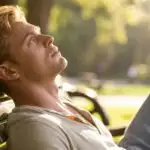 Man Resting on Park Bench Looking at the Sky